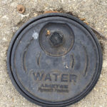 Picture of a black, round curb box