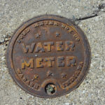 Picture of an old looking, cast iron water meter box